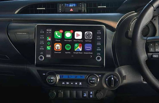Toyota Hilux (2022-2025), Touchscreen with smartphone connectivity above dual-dial climate controls.