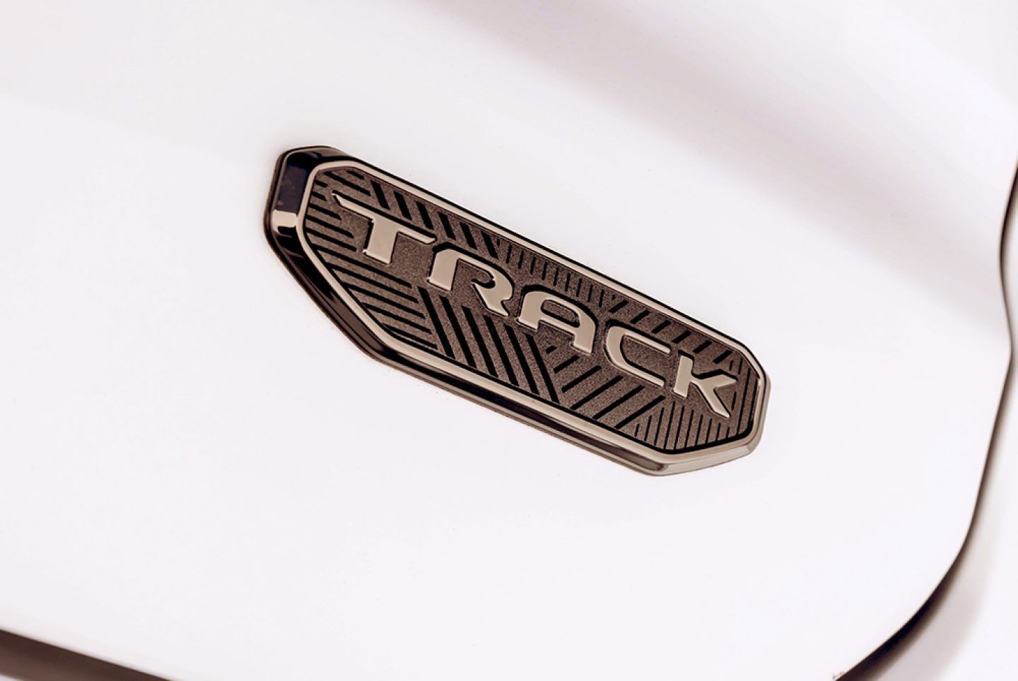 Jeep Meridian — Track Edition badge in a gunmetal finish on the body panel.