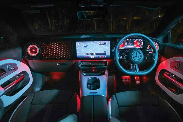 Mercedes-Benz CLA Electric — MBUX Superscreen spanning the dashboard with star-pattern trim and red ambient lighting.