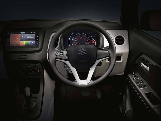 Maruti Suzuki Wagon R, Driver-focused dashboard with a floating touchscreen, twin-pod analogue instrument cluster, silver accents and steering-mounted controls.