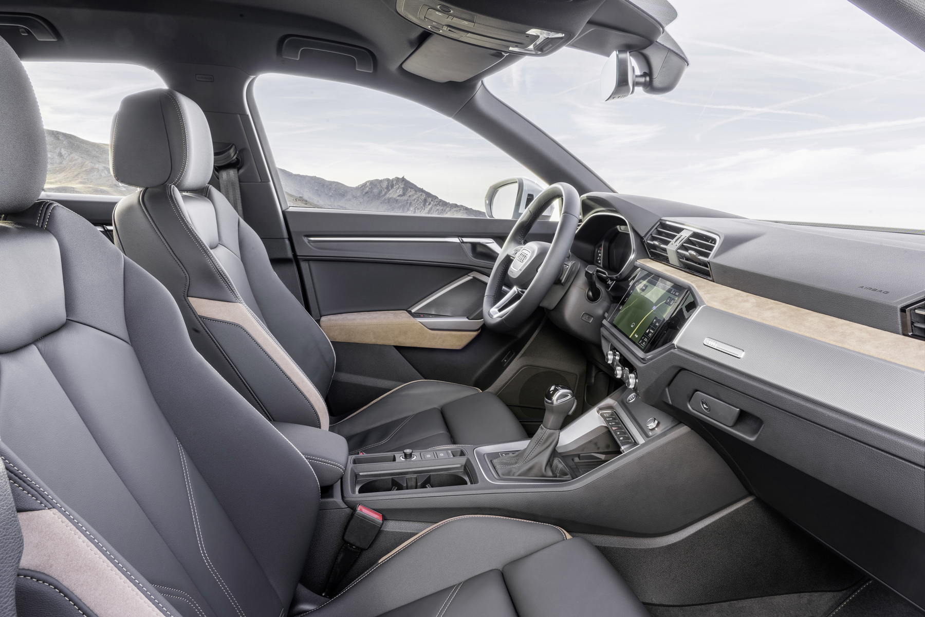 Audi Q3 — Front sport seats in leather/leatherette upholstery with contrast stitching.