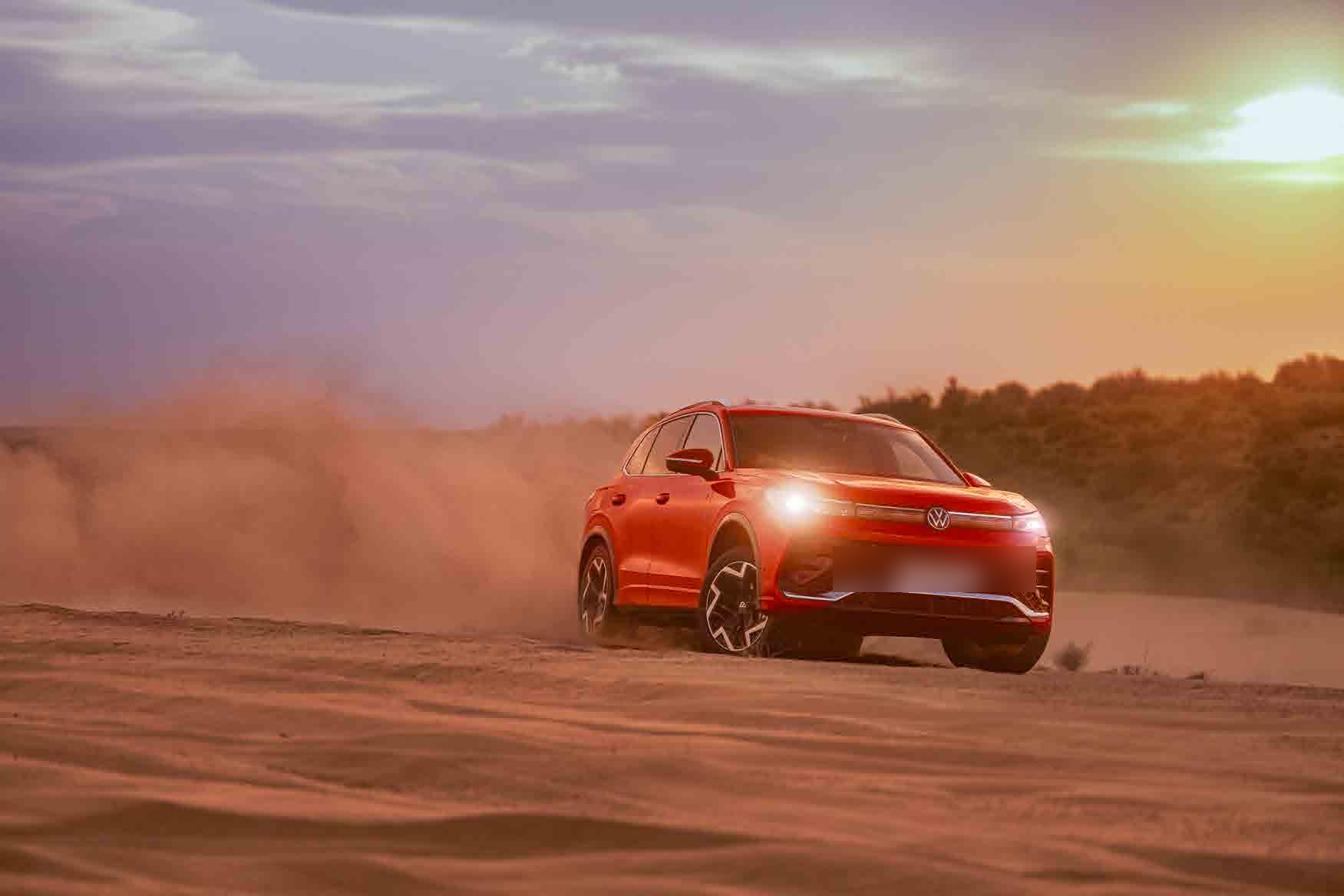 Volkswagen Tiguan R-Line — LED matrix headlamps lit up on a dusk desert drive