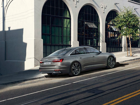 Audi A6, Rear three-quarter showing the coupe-like roofline and full-width LED tail-light strip