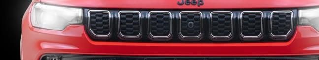 Jeep Compass — Illuminated seven-slot grille with a gloss-black surround flanked by lit full-LED headlamps.