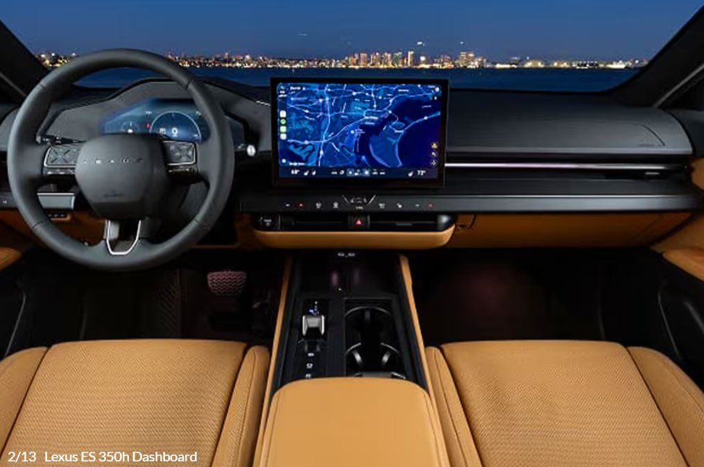 Luxury car interior with tan leather seats, steering wheel, and navigation display at night.