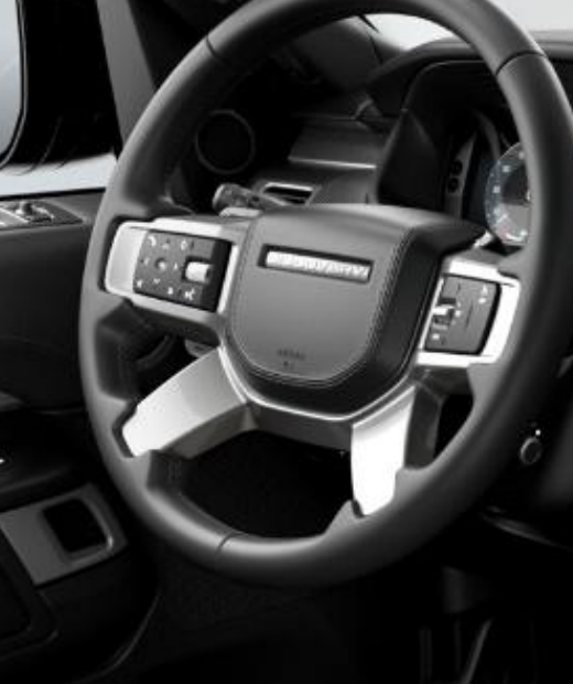 Land Rover Discovery — Leather multi-function steering wheel with tactile switch controls and a metal paddle behind the rim.
