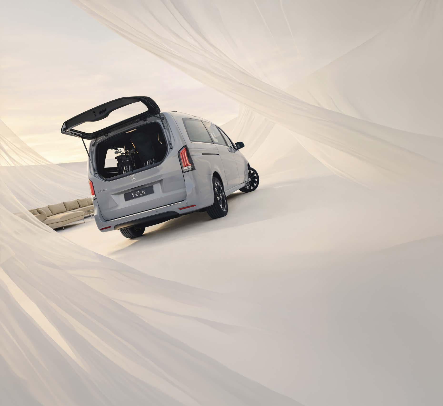 Mercedes-Benz V-Class — Split-opening tailgate with an independently opening rear window and a chrome highlight along the lower edge; third-row seats fold and can be removed.