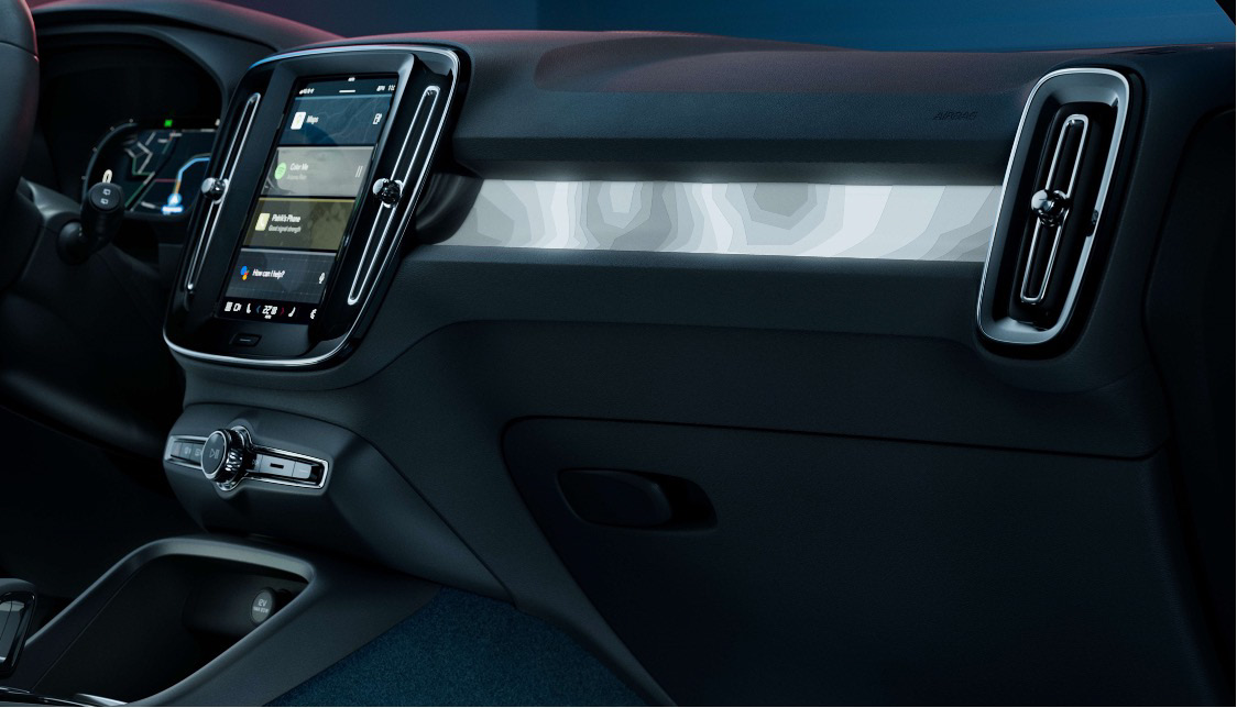 Volvo EC40 — Portrait centre touchscreen running Google built-in, set above the backlit topography-inspired decor trim.