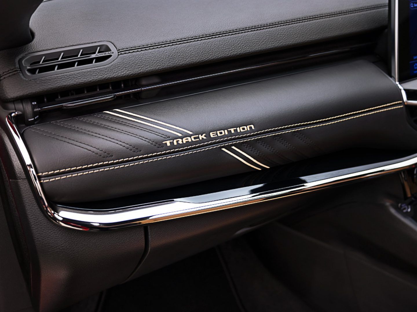 Jeep Compass — Track Edition gold-embroidered dashboard trim.
