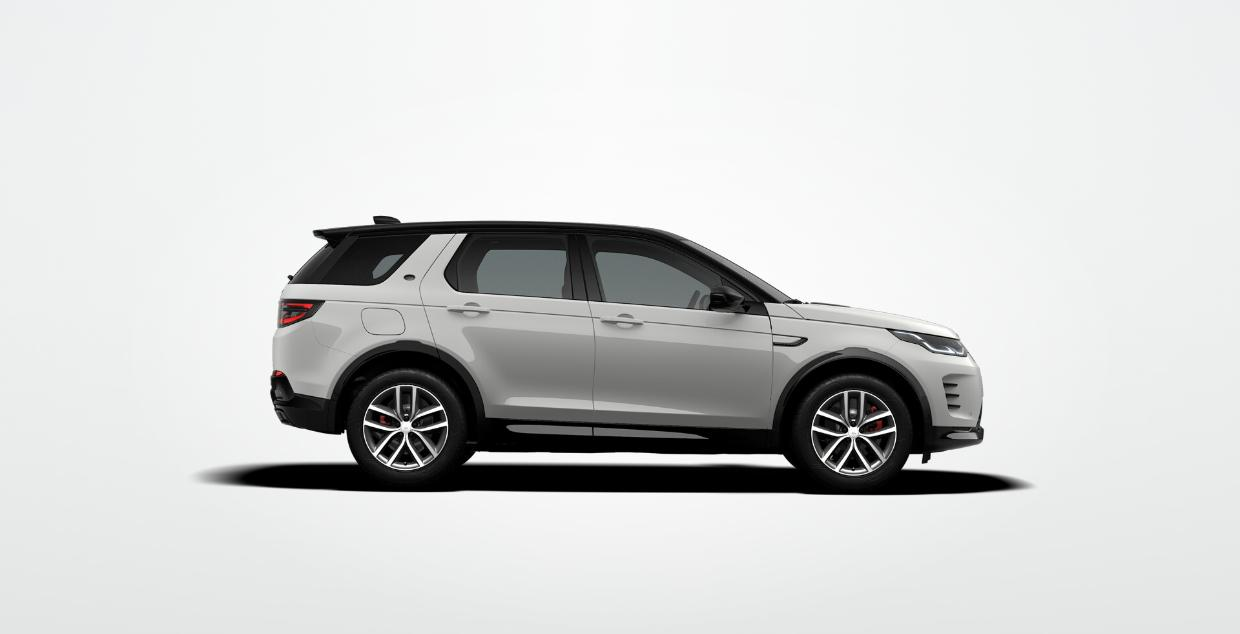 Land Rover Discovery Sport — Side profile on 46.26 cm (19-inch) Gloss Dark Grey diamond-turned alloy wheels with red brake calipers and a black contrast roof.