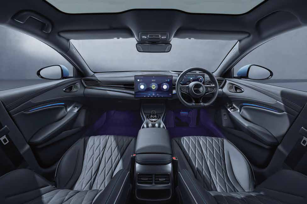 BYD Seal — Driver-focused cockpit with rotating central touchscreen and blue ambient interior lighting.