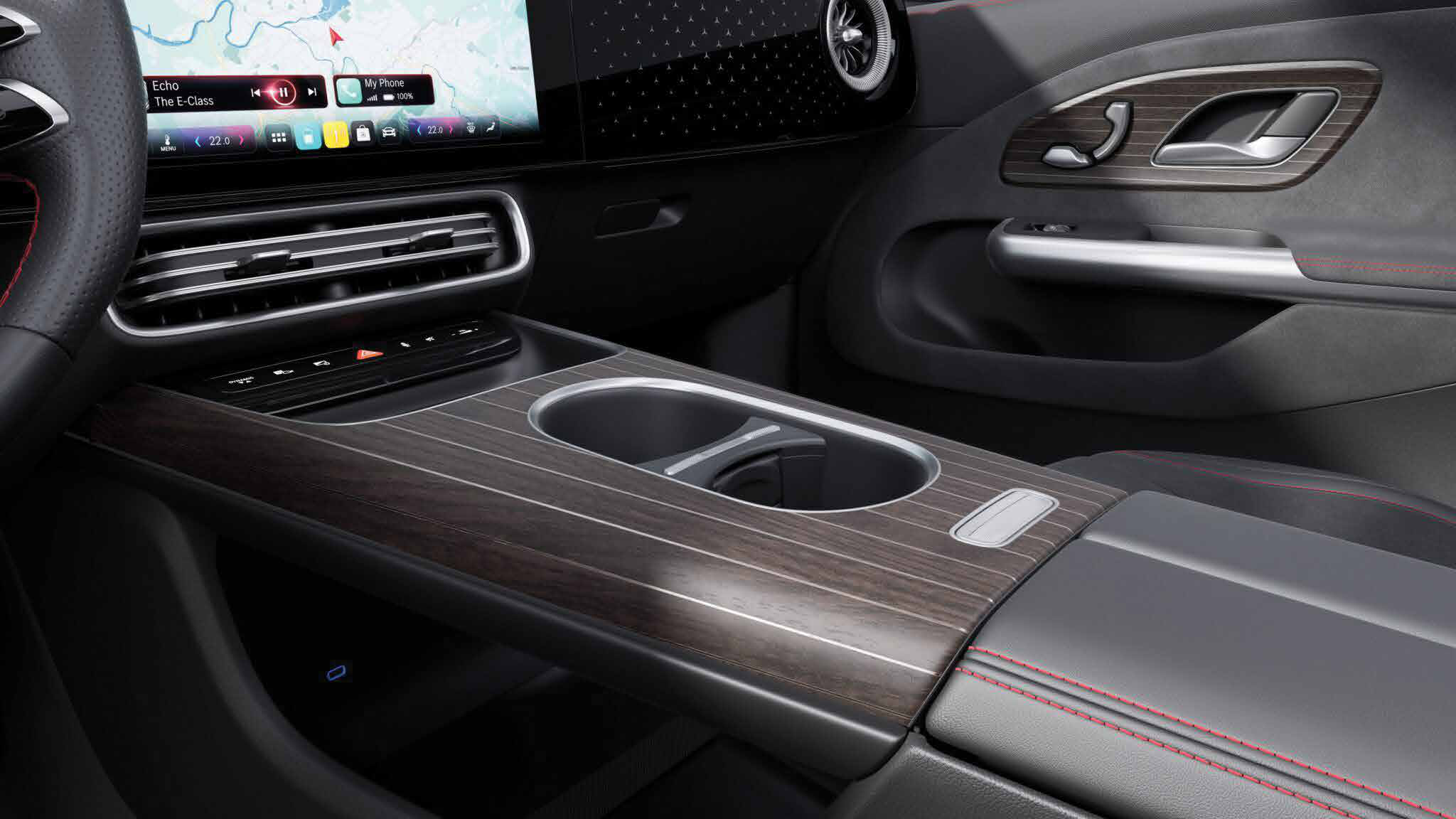 Mercedes-Benz CLA Electric — Open-pore wood centre console with twin cup holders and phone connectivity.