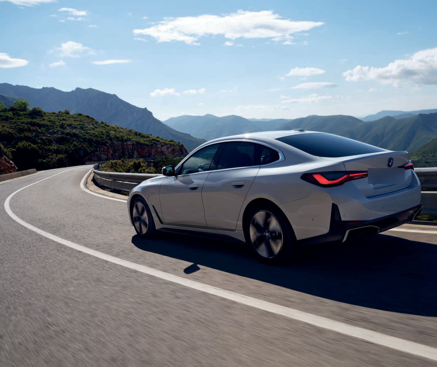 BMW i4 — Rear-wheel-drive BMW eDrive powertrain with rear-axle air suspension delivers sporty handling with long-distance comfort.