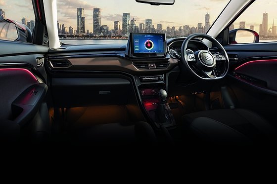Maruti Suzuki Brezza, Dark brown and black cabin with a flat-bottom leather-wrapped steering wheel, floating touchscreen and 64-colour ambient lighting.