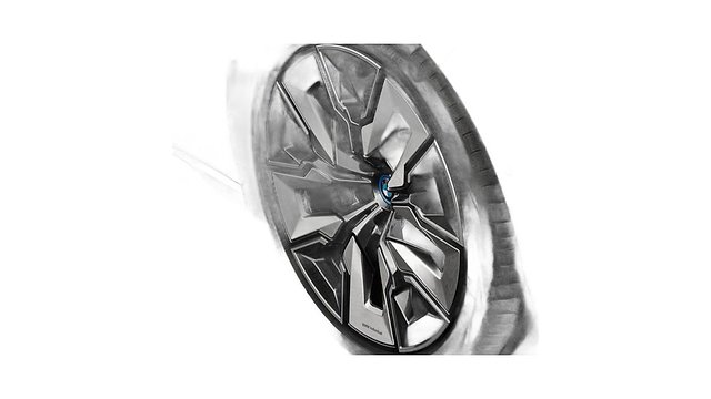Modern multi-spoke alloy wheel with blue center cap and dark tire.
