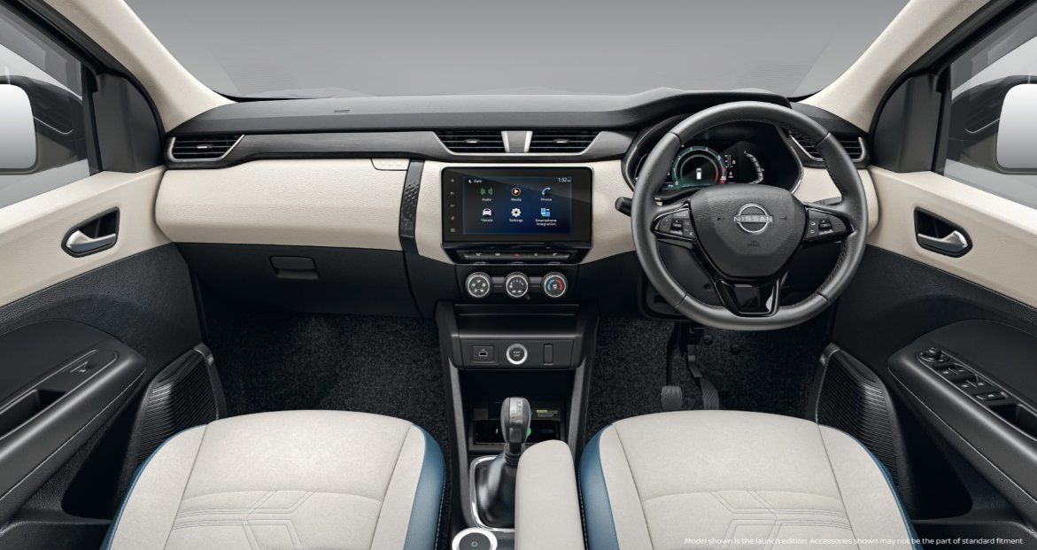 Car interior with cream and black seats, touchscreen display, and steering wheel.