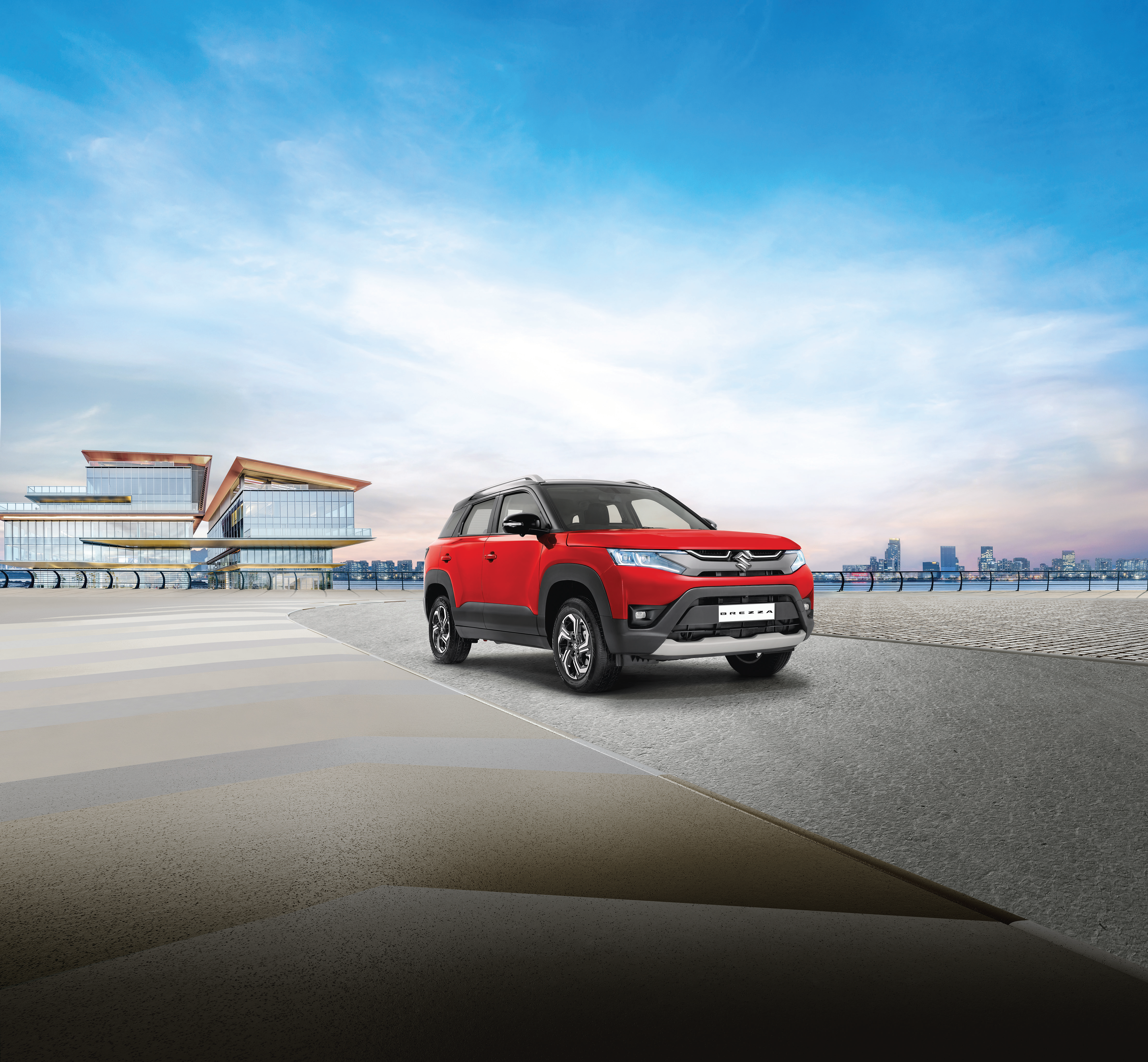 Maruti Suzuki Brezza — Front three-quarter stance with dual-tone roof, LED projector headlamps and body cladding.