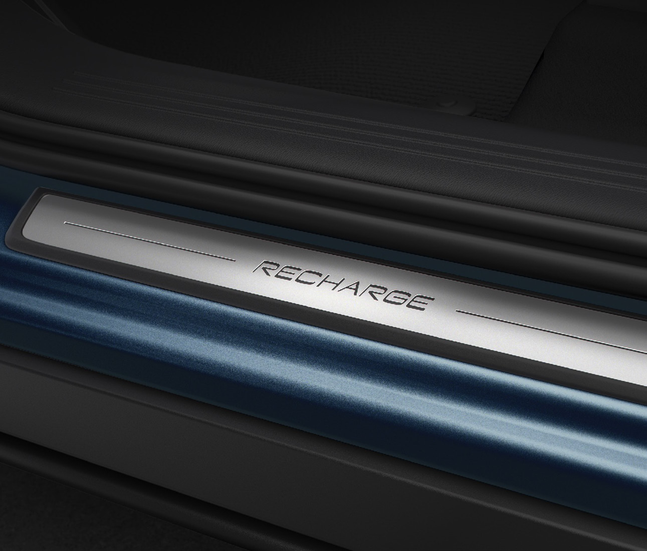 Volvo EC40 — Illuminated metal 'RECHARGE' front door sill plate.