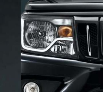 Mahindra Bolero — Restyled clear-lens headlamps with chrome bezel and amber turn indicators