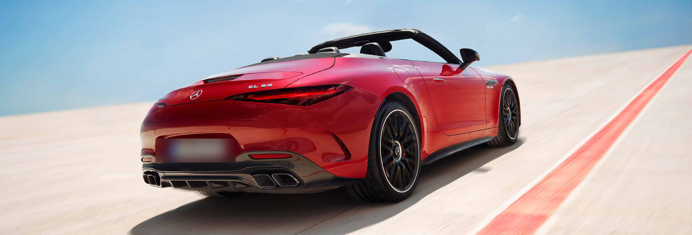 Mercedes-Benz Mercedes-AMG SL 55 Roadster — Rear three-quarter dynamic shot showing the quad tailpipes and AMG Performance 4MATIC+ all-wheel-drive stance