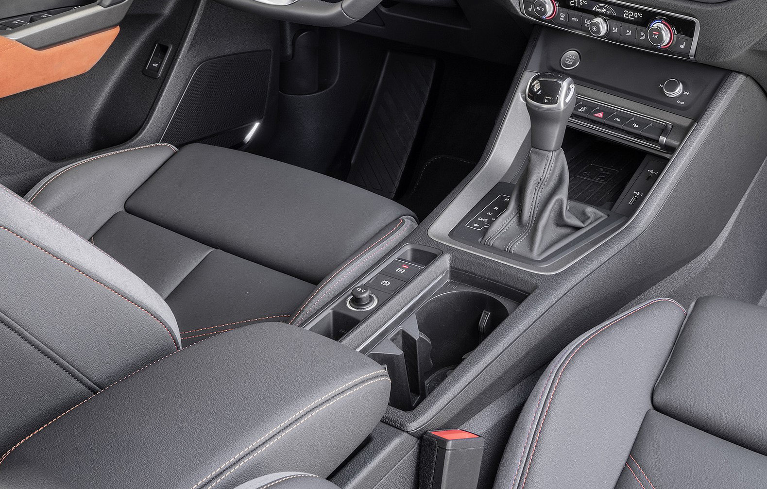 Audi Q3 — Front centre console with sliding comfort armrest, gear selector, cupholders and storage.