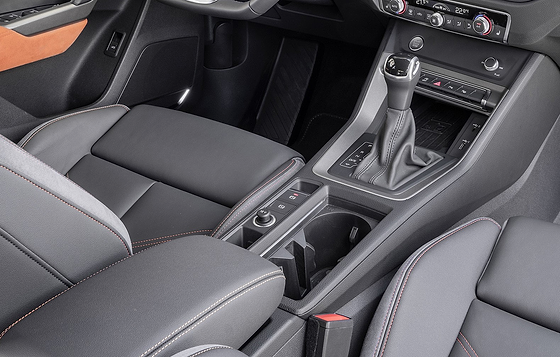 Audi Q3 (2022-2026), Front centre console with sliding comfort armrest, gear selector, cupholders and storage.