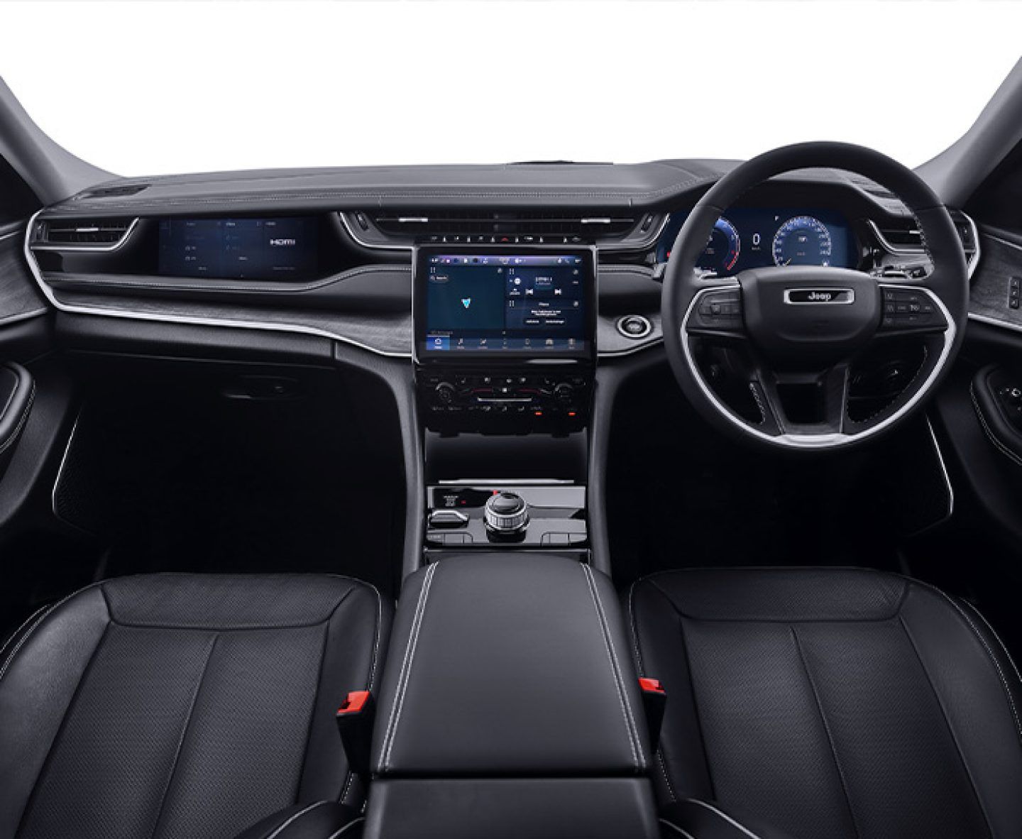 Jeep Grand Cherokee — Front cabin trimmed in perforated black leather, with a floating centre console housing the rotary drive-mode selector ahead of the driver-oriented touchscreen.