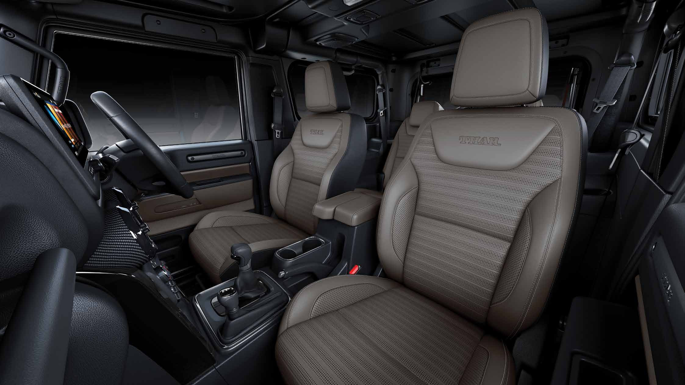 Mahindra Thar OG, Front seats seen from the passenger side: tan perforated leatherette upholstery with THAR embossed on the headrests, cen