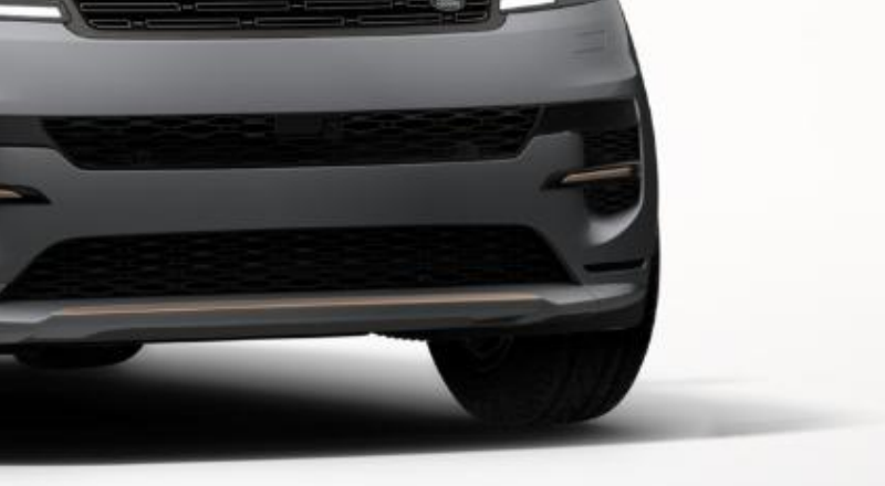 Land Rover Range Rover Sport — Sculpted front bumper with gloss-black mesh lower air intakes and bronze accent detailing.