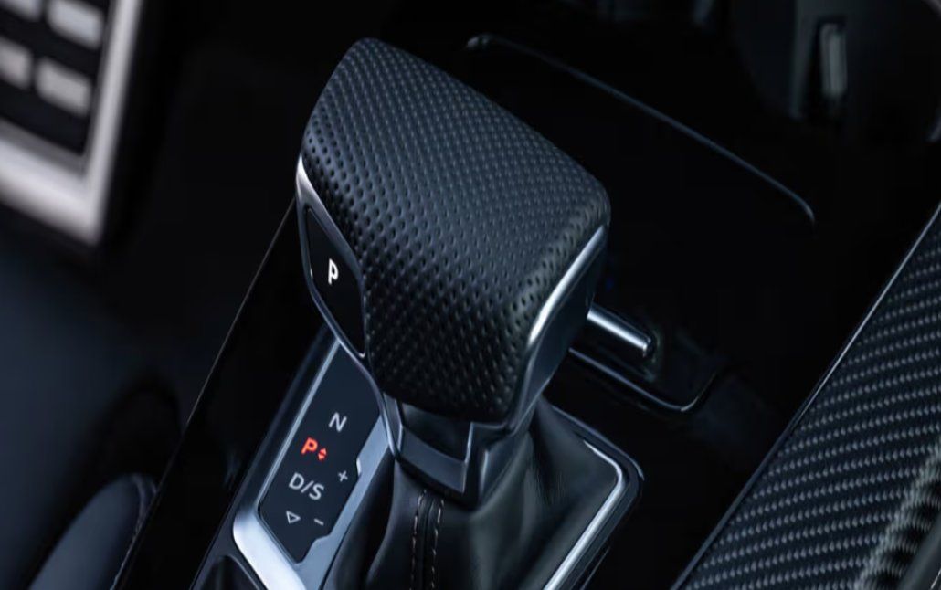 Automatic transmission shifter with P, R, D/S modes in dark interior.