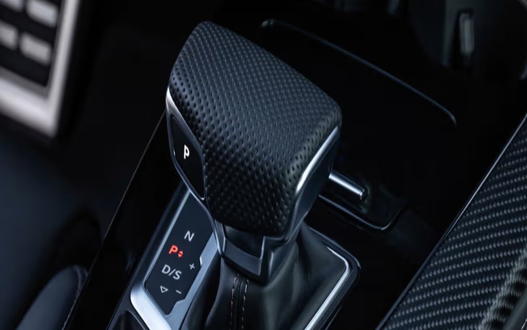 Automatic transmission shifter with P, R, D/S modes in dark interior.