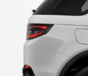 Land Rover Discovery Sport — LED tail-lamp set into the rear haunch, shown from the rear three-quarter on the Fuji White body.