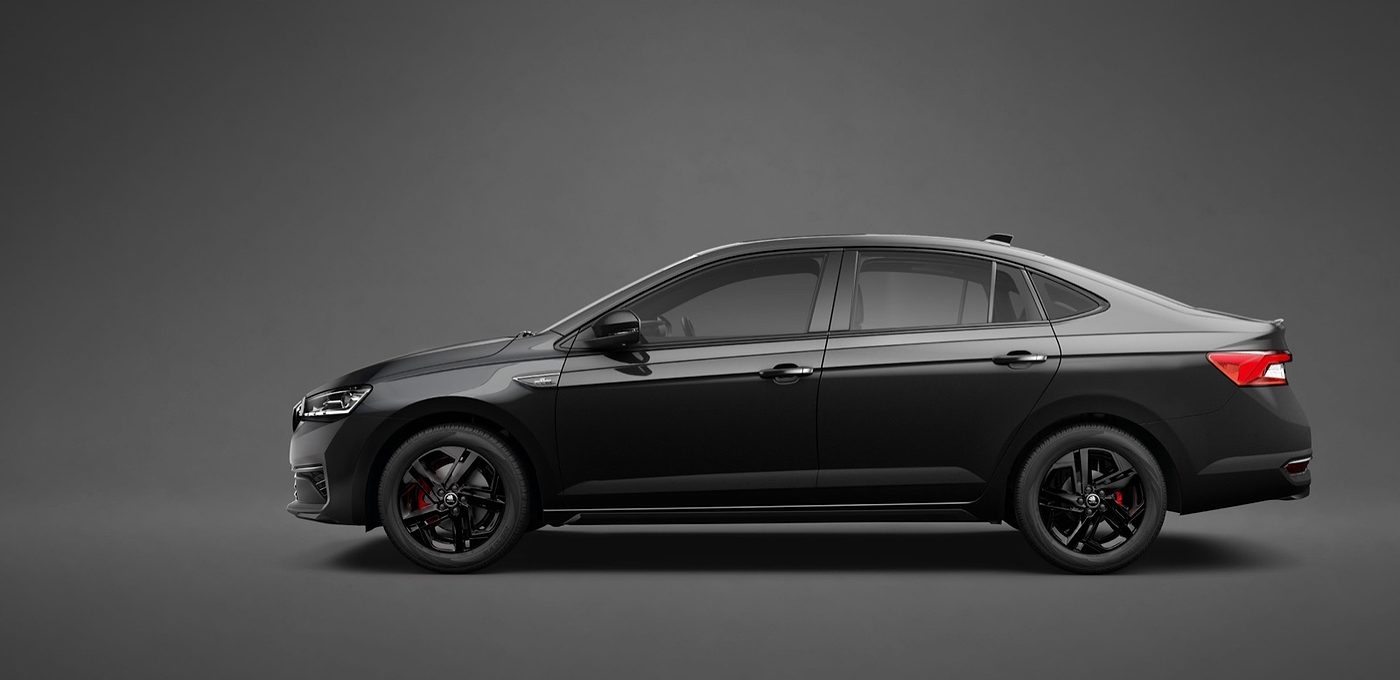 2026 Škoda Slavia Monte Carlo side profile showing the sedan silhouette, black R16 Savio alloy wheels and red brake calipers