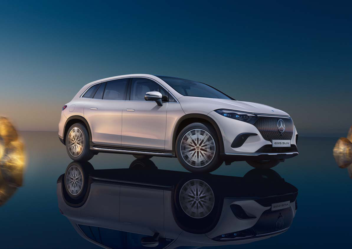 Mercedes-Benz EQS SUV — Front three-quarter view of the EQS SUV in AMG Line trim with the sealed black-panel grille and full-width LED light bar