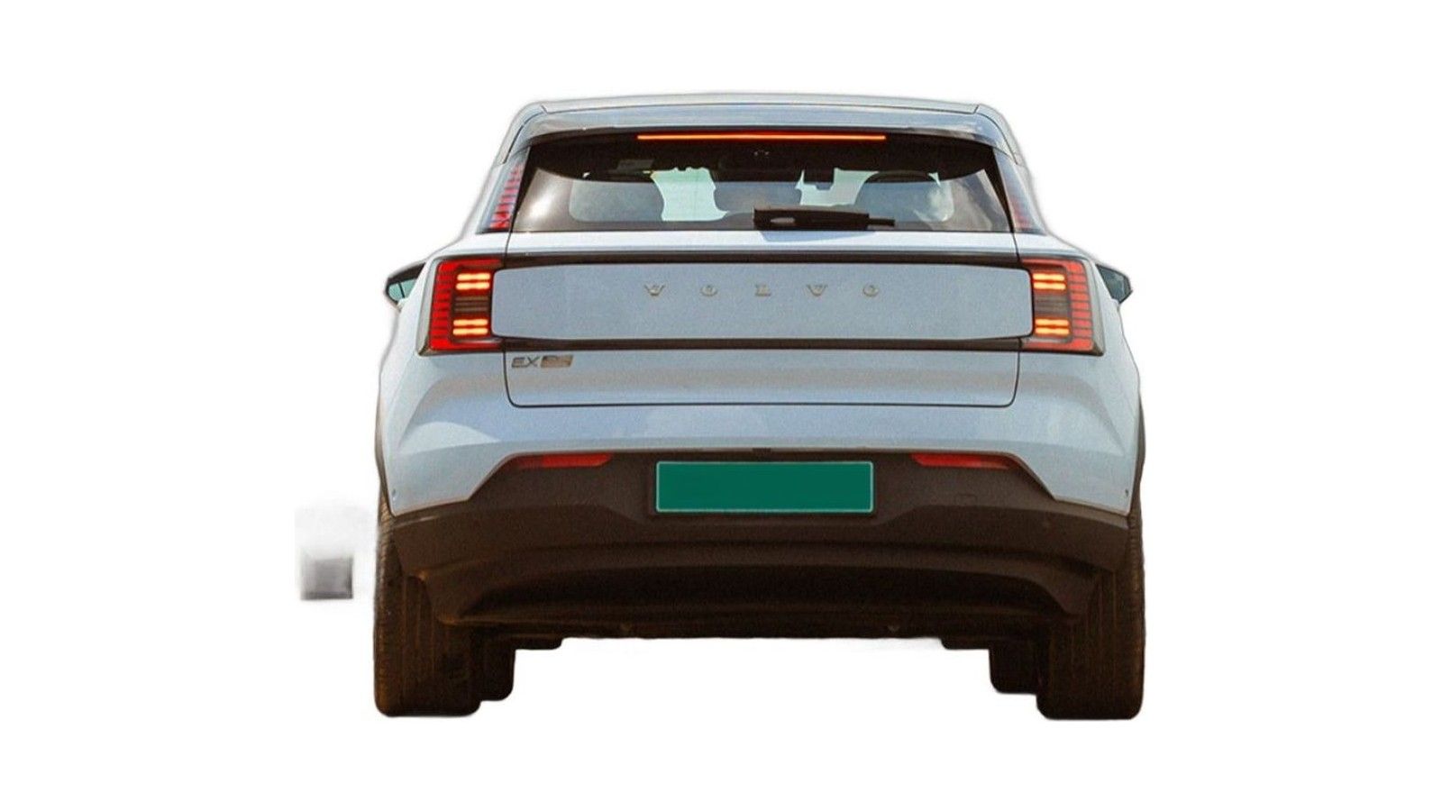 Rear view of a silver electric hatchback with red taillights and green license plate.