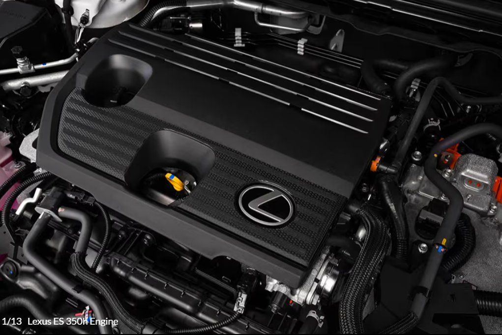 Engine bay of Lexus ES 350h hybrid showing carbon fiber intake cover and components.