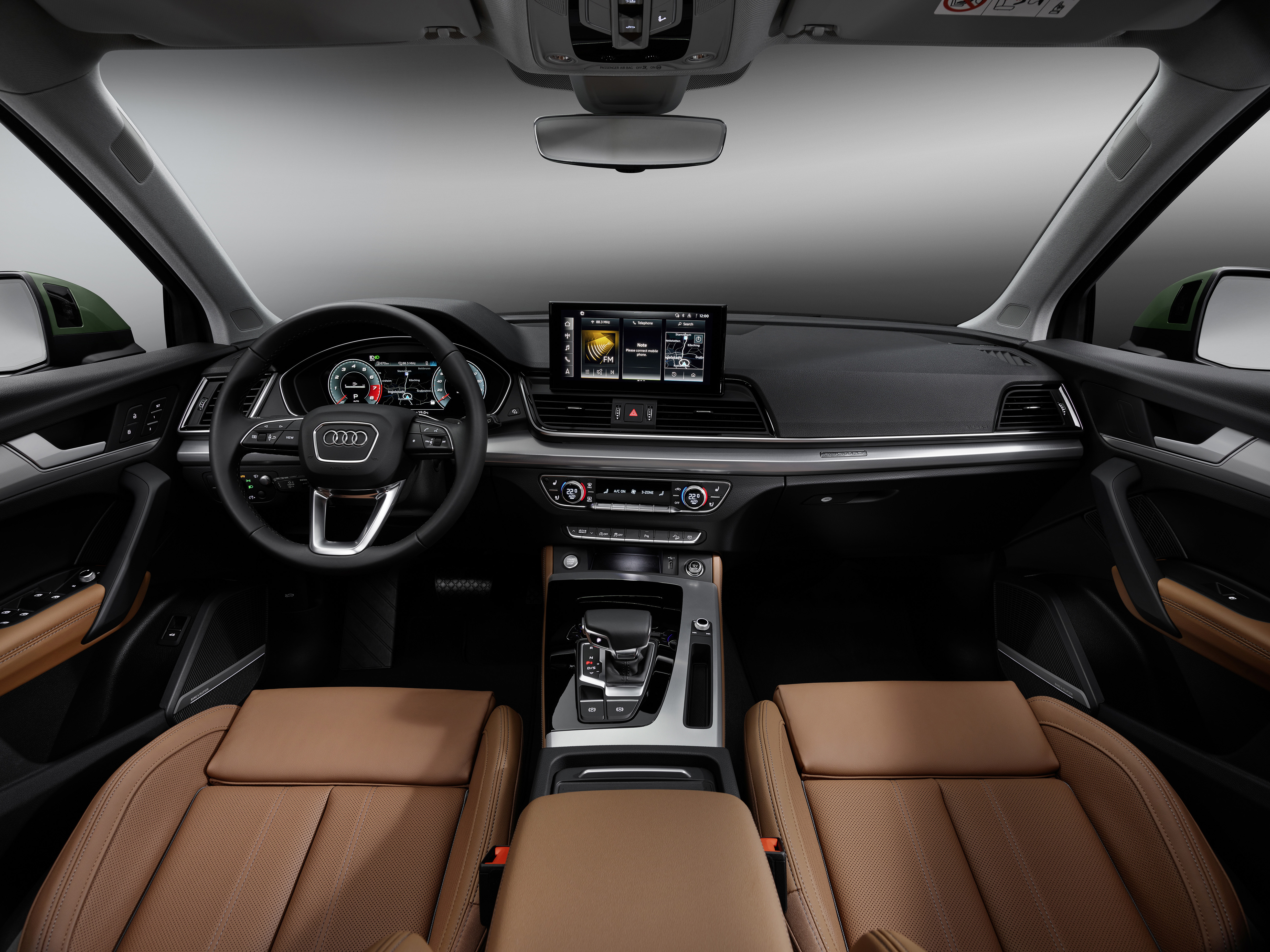Audi Q5 — Driver-focused cabin with brown leather upholstery, the Virtual Cockpit and MMI touch display.