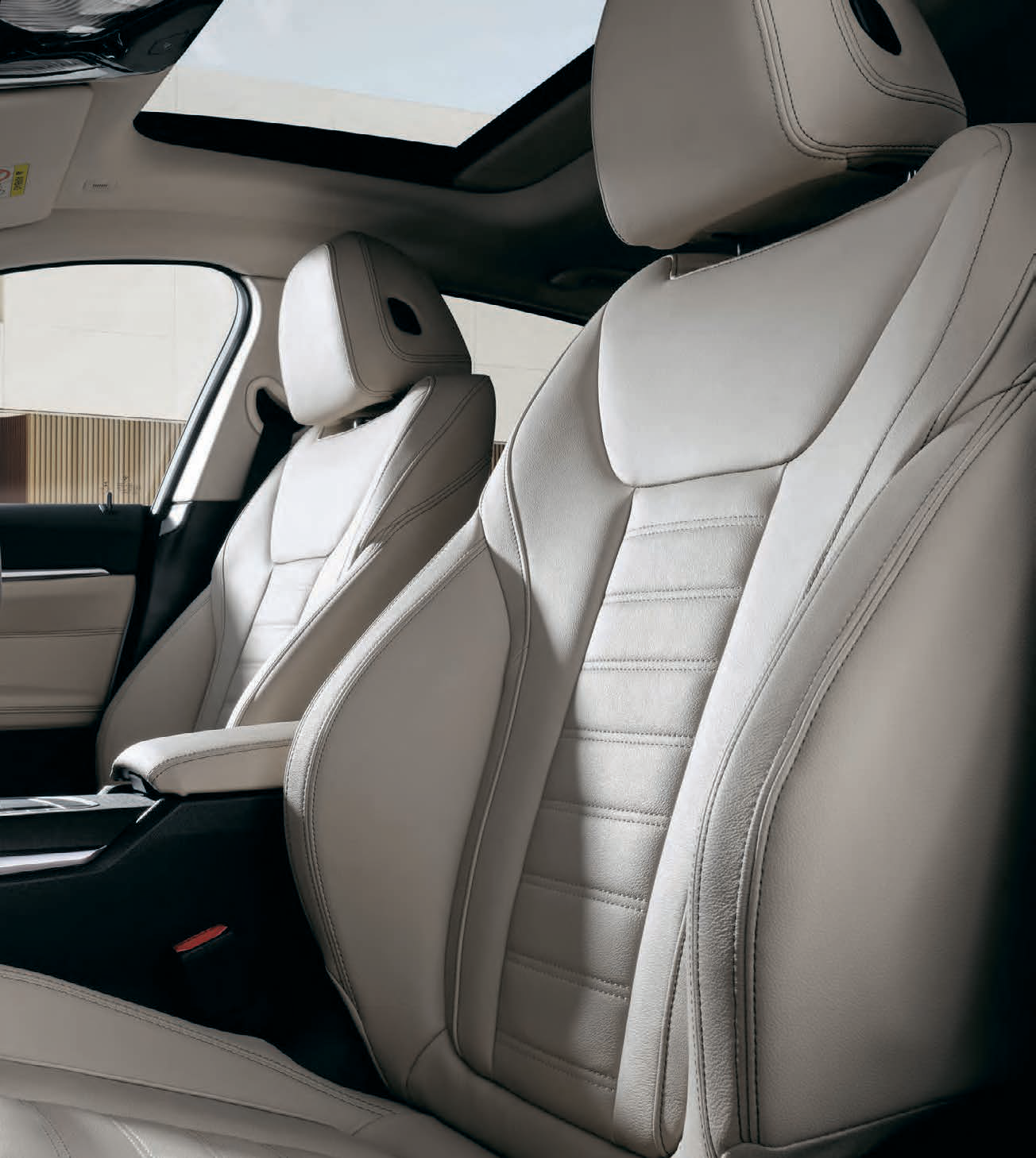 BMW i4 — Front sport seats in perforated Sensatec upholstery with contrast stitching and raised side bolsters for lateral support.