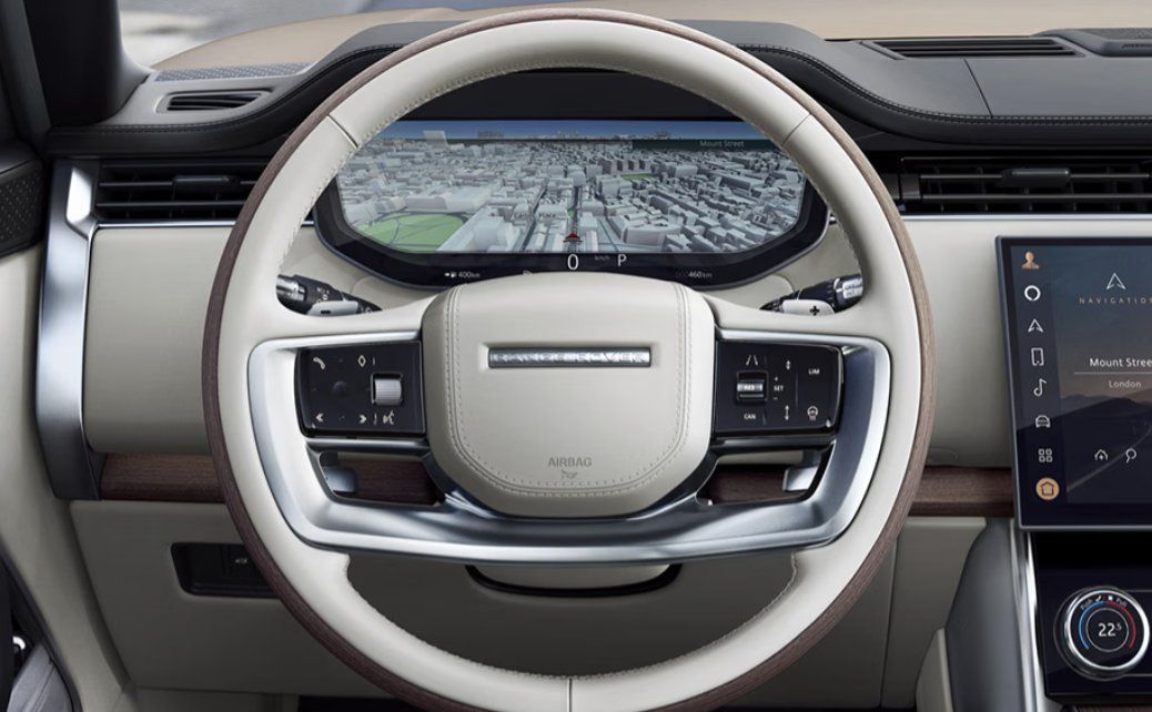 Luxury SUV interior with cream steering wheel displaying aerial city map navigation.