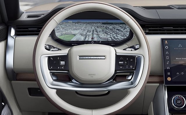 Luxury SUV interior with cream steering wheel displaying aerial city map navigation.