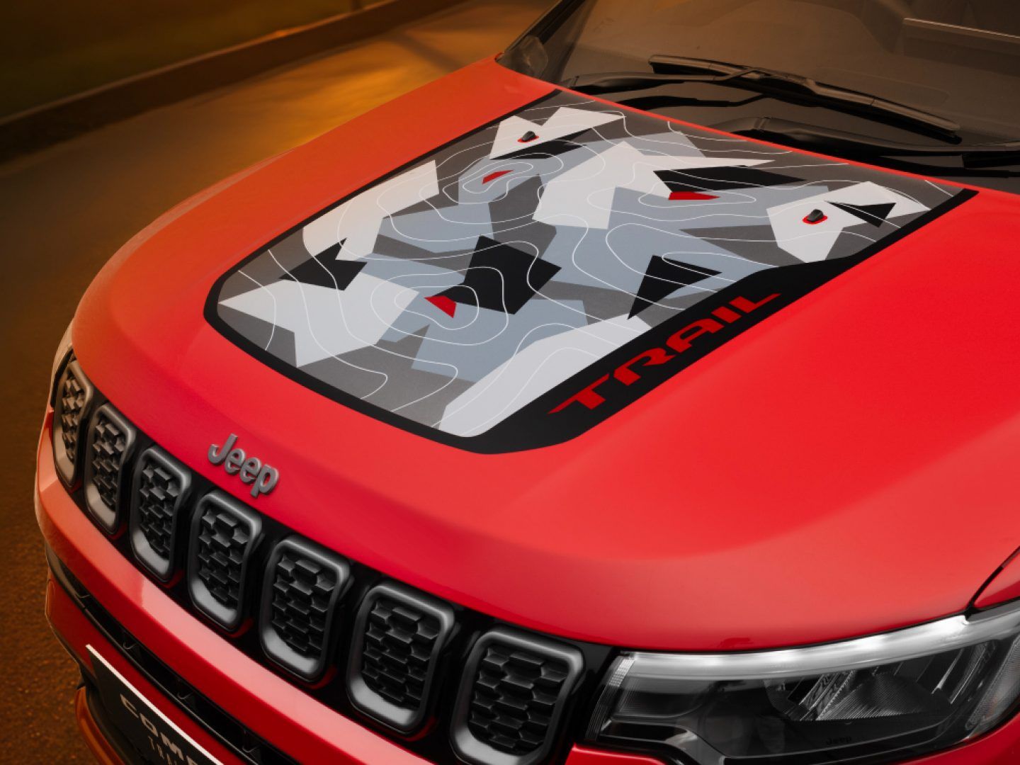 Jeep Compass — Trail Edition camouflage hood graphic and blacked-out seven-slot grille.