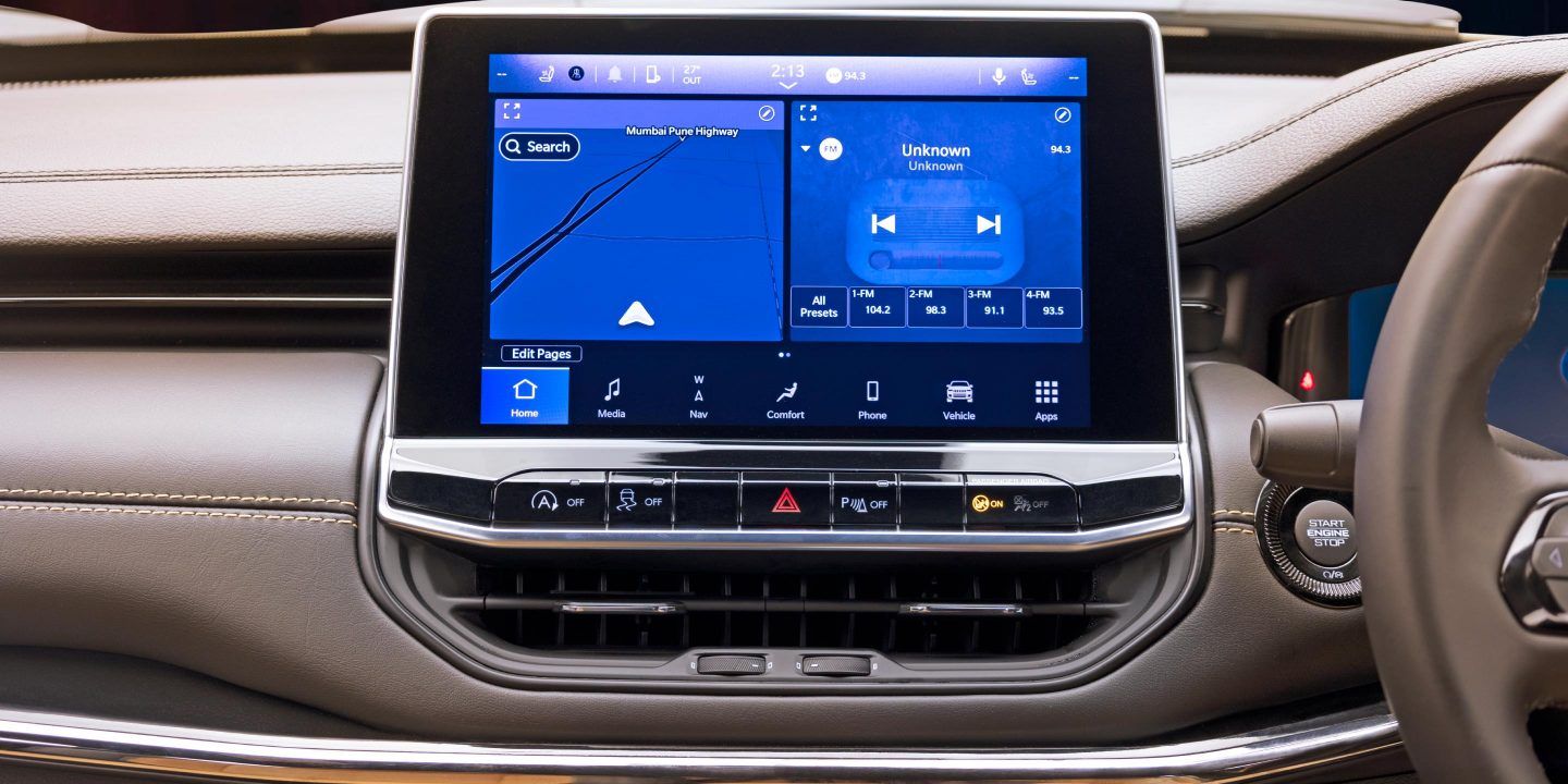 Jeep Compass — Split-screen infotainment running navigation and media side by side.