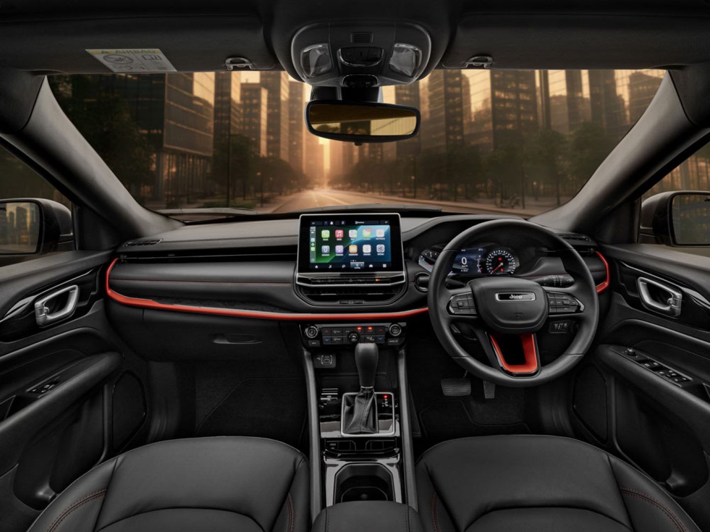 Jeep Compass — Driver-focused dashboard with a floating touchscreen and a red-accent trim line running across the fascia.