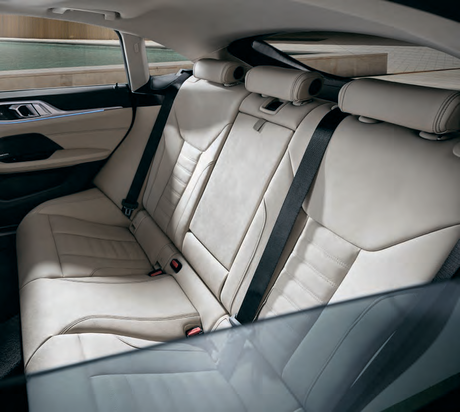 BMW i4 — Rear bench seats up to three passengers with generous head and leg room; the backrest folds to expand luggage space.