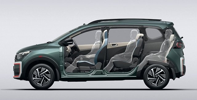 Green MPV with sliding doors open, showing five seats and interior layout.