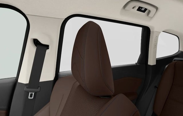 Rear car interior with brown leather seats, windows, and overhead controls.