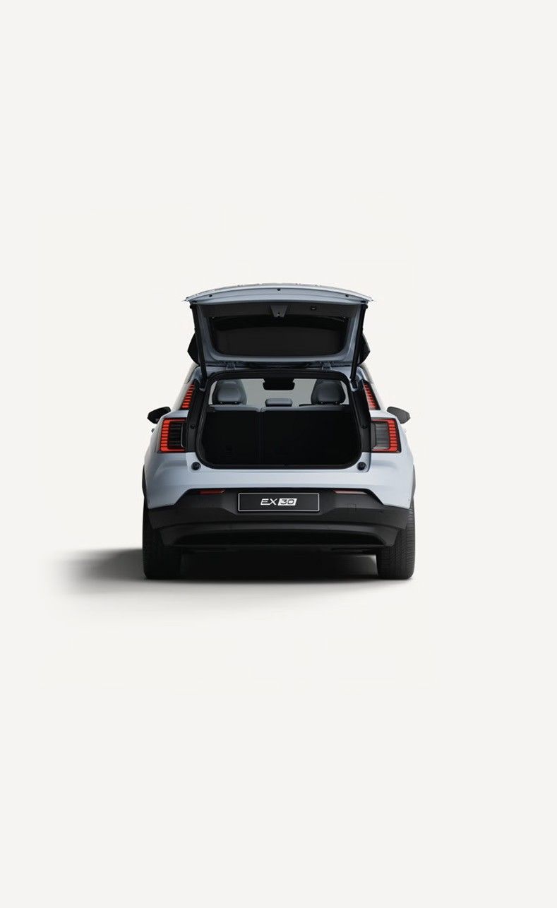 Volvo EX30 — Open tailgate revealing the rear luggage compartment with the rear seatbacks folded flat.