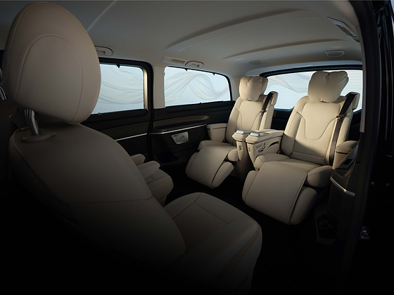 Mercedes-Benz V-Class, Ventilated multicontour rear seats with adjustable calf support recline within the beige-leather cabin, ahead of the removable third row.