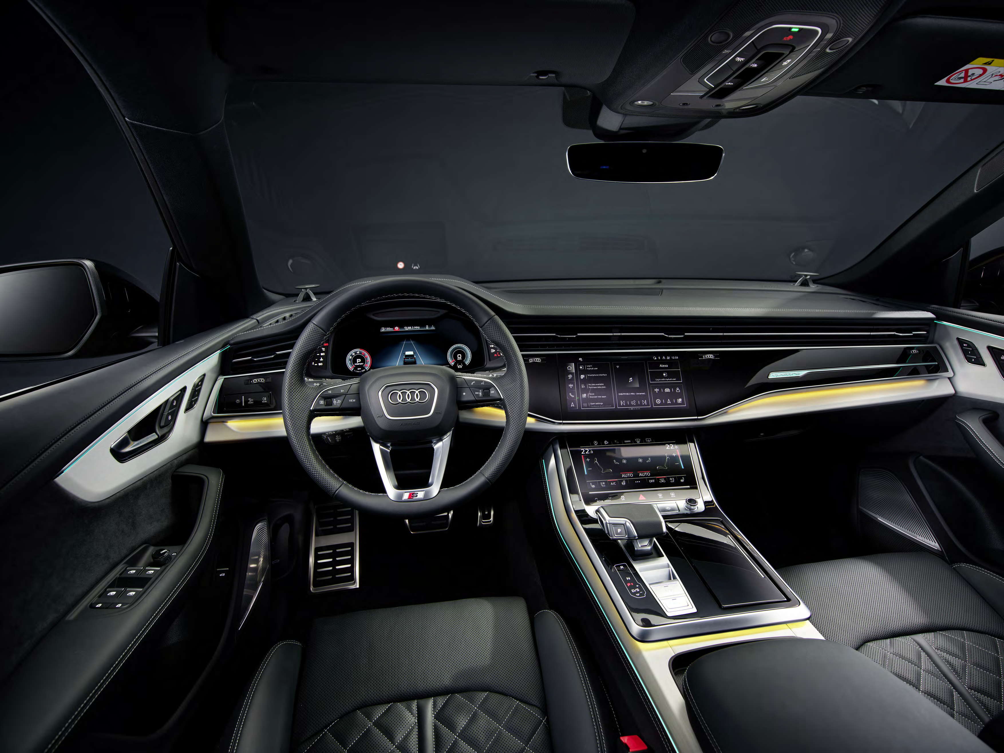 Audi Q8 — Driver-focused cabin with dual displays, S-line steering wheel and centre console.